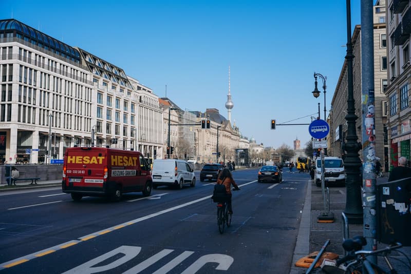 Cyclist in a marked lane on a Berlin boulevard with the TV tower behind
