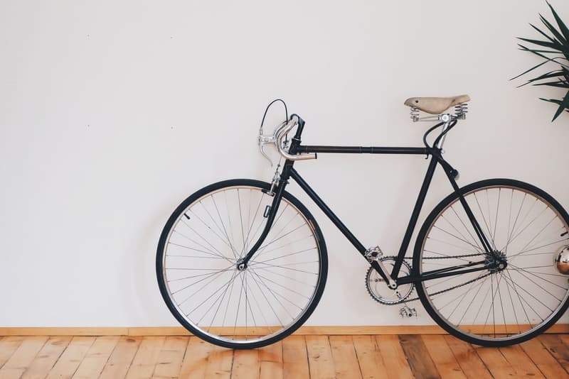 Classic steel road bicycle with a leather saddle indoors