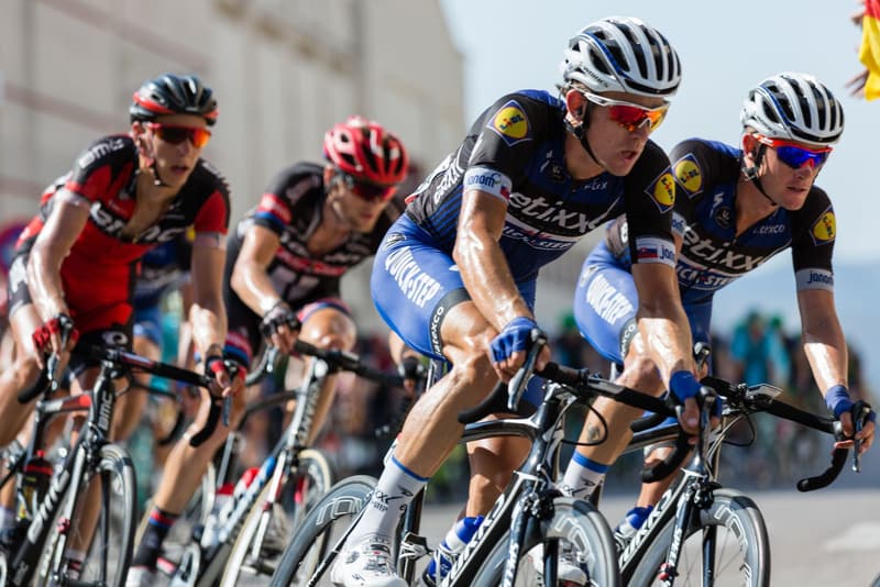 Professional road racers riding tight together in the peloton
