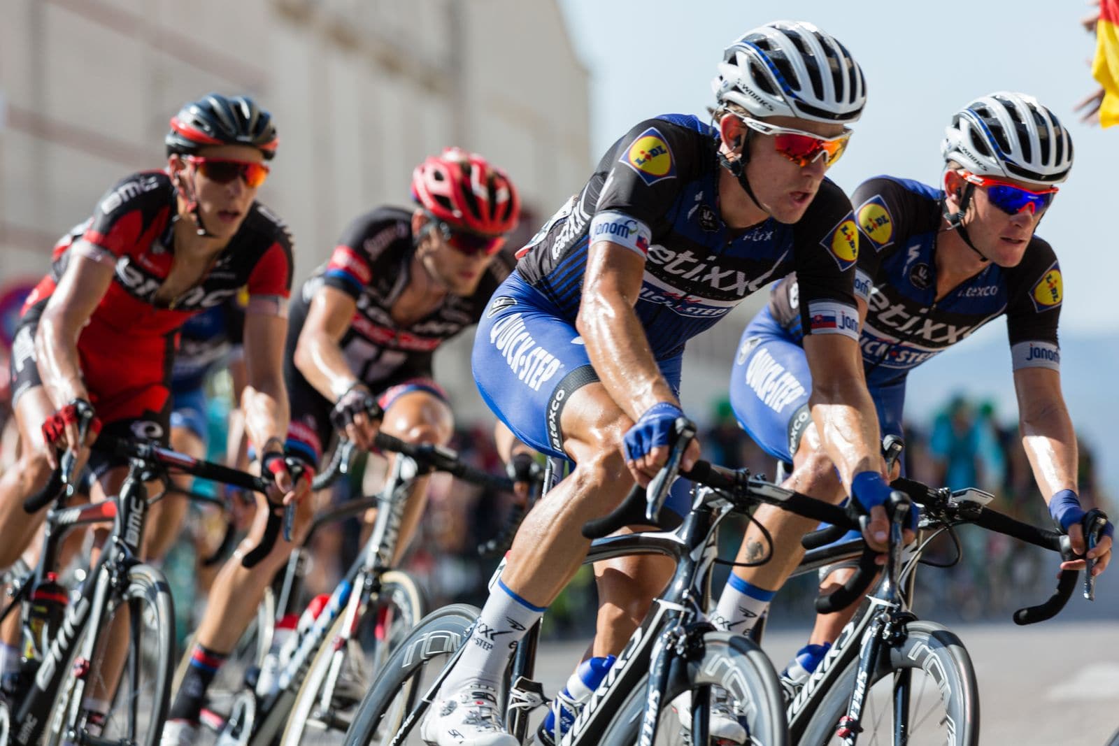 Professional road racers riding tight together in the peloton