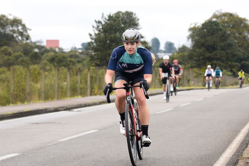 Road cyclist leading a small training group along an open road